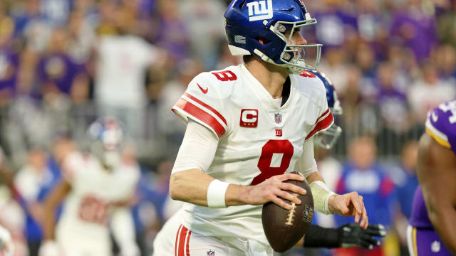 Jan 15, 2023; Minneapolis, Minnesota, USA; New York Giants quarterback Daniel Jones (8) runs with the ball as he looks to pass the ball against the Minnesota Vikings during the first quarter of a wild card game at U.S. Bank Stadium.